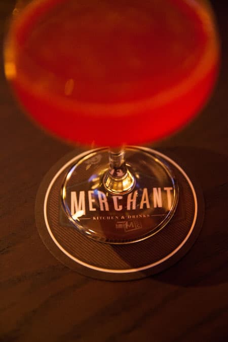 A signature cocktail on a Merchant coaster